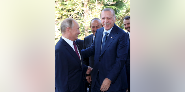 Russian President Vladimir Putin, left, welcomes Turkey's President Recep Tayyip Erdogan, prior to their talks at the Bocharovy Ruchei residence, in Sochi, Russia, Monday, Sept. 17, 2018. The leaders of Russia and Turkey agreed Monday to establish a demilitarized zone in Syria's Idlib region. (Presidential Press Service via AP, Pool)