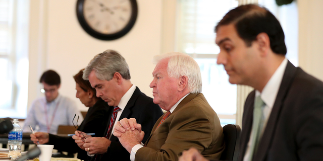 Martin P. Duffey, left, Christopher C. Fallon Jr., center, who are lawyers for Johnny Bobbitt, and Ernest E. Badway, right, who is the lawyer for the Kate McClure and Mark D'Amico, listen during a hearing on missing funds in the Johnny Bobbitt case in the Olde Historic Courthouse in Mt. Holly, NJ, Wednesday, Sept. 5, 2018. McClure and D'Amico are accused of mismanaging the money raised for Bobbitt. (David Maialetti/The Philadelphia Inquirer via AP, Pool)