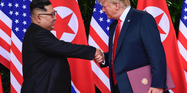 FILE - In this June 12, 2018 file photo, North Korea leader Kim Jong Un and U.S. President Donald Trump shake hands at the conclusion of their meetings at the Capella resort on Sentosa Island in Singapore. The newly appointed U.S. special envoy for North Korea will make his first diplomatic trip abroad next week in the Trump administration’s latest effort to press for progress in uncertain denuclearization talks. (AP Photo/Susan Walsh, Pool)