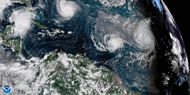 CORRECTS DATE TO SEPT. 11, NOT 1 - This enhanced satellite image made available by NOAA shows Tropical Storm Florence, upper left, in the Atlantic Ocean on Tuesday, Sept. 11, 2018 at 3:30 p.m. EDT. At center is Tropical Storm Isaac and at right is Hurricane Helene. (NOAA via AP)
