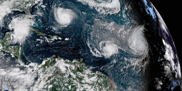 CORRECTS DATE TO SEPT. 11, NOT 1 - This enhanced satellite image made available by NOAA shows Tropical Storm Florence, upper left, in the Atlantic Ocean on Tuesday, Sept. 11, 2018 at 3:30 p.m. EDT. At center is Tropical Storm Isaac and at right is Hurricane Helene. (NOAA via AP)