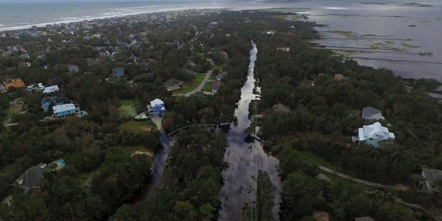 Coast Guard Road leading to the south end of Emerald Isle is seen after Hurricane Florence hit Emerald Isle, N.C., Sunday, Sept. 16, 2018. (AP Photo/Tom Copeland)