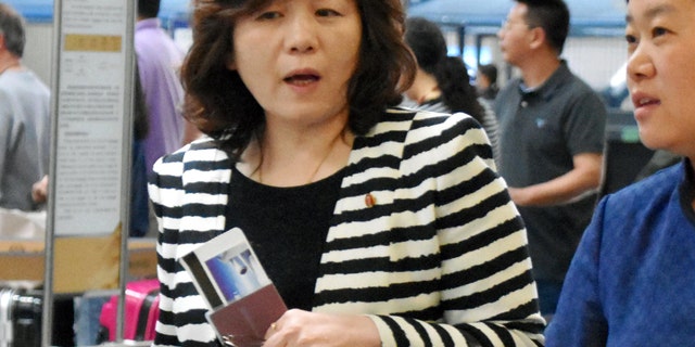 Choi Sun-hee, left, the top North Korean diplomat who handles relations with the U.S. walks prior to her departure for Pyongyang, North Korea, at Beijing Capital International Airport in Beijing Saturday, May 13, 2017. Choi said Pyongyang would be willing to meet with the Trump administration for negotiations "if the conditions are set," briefly to reporters en route to Pyongyang. She was traveling from Norway, where she led a delegation that held an informal meeting with U.S. experts. (Kyodo News via AP)