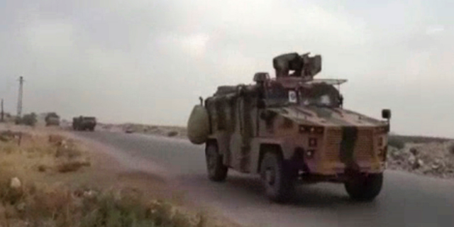 This frame grab from video provided by Central Station for Turkish Intervention, an activist-operated media group monitoring Turkish activities in Syria, that is consistent with independent AP reporting, shows a Turkish military convoy heading to some of the 12 Turkish observations points that ring Idlib, Syria, Thursday, Sept. 13, 2018. Turkey sent in military reinforcements Thursday to beef up its positions inside Syria's last rebel bastion Idlib, activists reported, even as the Turkish defense minister said Ankara is still trying with Russia and Iran to prevent a humanitarian tragedy in the case of a threatened Syrian government offensive. (Central Station for Turkish Intervention, via AP)