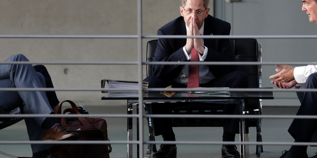 FILE-- In this Wednesday, Sept. 12, 2018 photo Hans-Georg Maassen, center, head of the German Federal Office for the Protection of the Constitution, waits for the beginning of a hearing at the home affairs committee of the German federal parliament, Bundestag, in Berlin, Germany. The leaders of Germany's three governing parties are meeting in Berlin on Tuesday to decide the fate of the country's domestic intelligence chief amid calls for him to be fired over his approach to far-right extremism. (AP Photo/Michael Sohn, file)