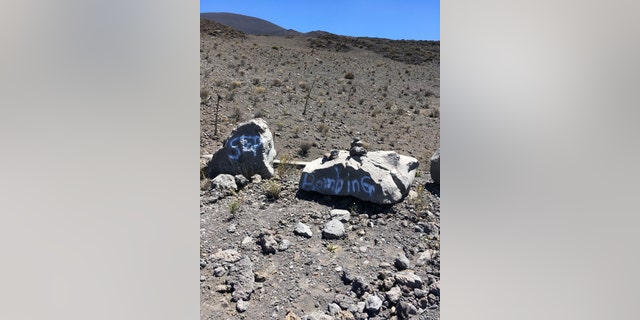 This undated photo provided by the Hawaii Department of Land and Natural Resources shows graffiti within a protected area on one of Hawaii's most revered mountains in the Mauna Kea Ice Age Reserve. The department said the graffiti was found on April 28, 2017, and authorities are asking for the public's help in finding out who painted the graffiti. (Hawaii Department of Land and Natural Resources via AP)