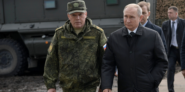 Russian President Vladimir Putin, right, and Head of the General Staff of the Armed Forces of Russia and First Deputy Defense Minister Valery Gerasimov arrive to attend military exercises about 80 kilometers (50 miles) north of the city of Chita during the military exercises Vostok 2018 in Eastern Siberia, Russia, Sept. 13, 2018. 