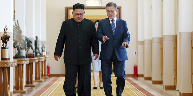 South Korean President Moon Jae-in, right, and North Korean leader Kim Jong Un walk together at the Paekhwawon State Guesthouse in Pyongyang, North Korea, Wednesday, Sept. 19, 2018. Moon and Kim have announced a sweeping set of agreements after their second day of talks in Pyongyang. It includes a promise by Kim to permanently dismantle the North's main nuclear complex if the United States takes corresponding measures, the acceptance of international inspectors to monitor the closing of a key missile test site and launch pad and a vow to work together to host the Summer Olympics in 2032.(Pyongyang Press Corps Pool via AP)