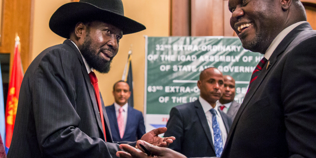 In this Thursday, June 21, 2018 file photo, South Sudan's President Salva Kiir, left, and opposition leader Riek Machar, right, shake hands during peace talks in Addis Ababa, Ethiopia.