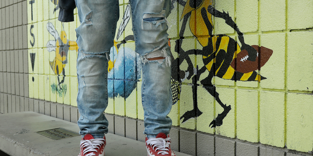 An Alameda High School student poses for photos wearing ripped jeans on the school's campus in Alameda, Calif., Thursday, Aug. 23, 2018. The relaxed new dress code at public schools in the small city of Alameda, across the bay from San Francisco, is intentionally specific: Midriff-baring shirts are acceptable attire, so are tank tops with spaghetti straps and other once-banned items like micro-mini skirts and short shorts. (AP Photo/Jeff Chiu)