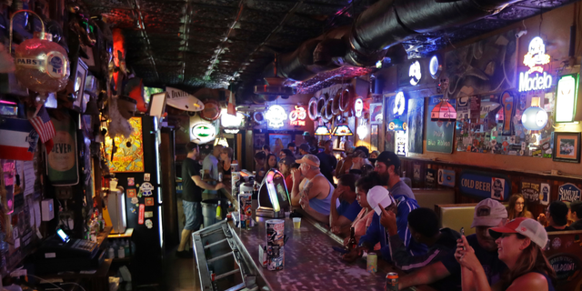 Locals have a drink as they relax at the Barbary Coast bar in downtown Wilmington, N.C., as  Florence threatens the coast Thursday, Sept. 13, 2018. (AP Photo/Chuck Burton)