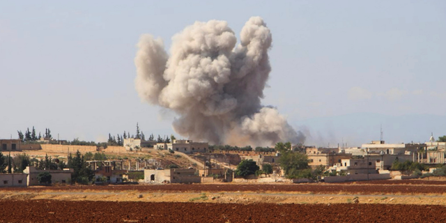 FILE - This file photo released on Monday, Sept 10, 2018 by the Syrian Civil Defense group known as the White Helmets, shows smoke rising from a Syrian government airstrike, in Hobeit village, near Idlib, Syria. As the decisive battle for Idlib looms, a motley crew of tens of thousands of Syrian opposition fighters, including some of the world's most radical, are digging their heels_ looking for ways to salvage what is possible of an armed rebellion that at one point in the seven-year conflict controlled more than half of the country. (Syrian Civil Defense White Helmets via AP, File)