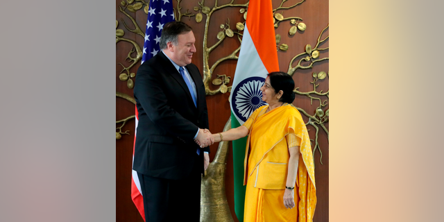U.S. Secretary of State Mike Pompeo, left, shakes hand with Indian Foreign Minister Sushma Swaraj before a meeting in New Delhi, India, Thursday, Sept. 6, 2018. Pompeo and Defense Secretary James Mattis are holding long-delayed talks Thursday with top Indian officials, looking to shore up the alliance with one of Washington's top regional allies. (AP Photo/Manish Swarup)