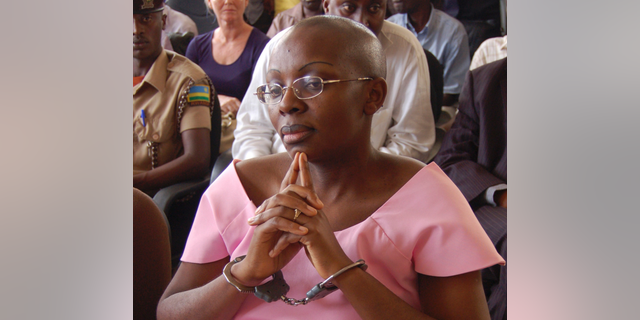 FILE - In this Monday, Sept. 5, 2011 file photo, Rwandan opposition leader Victoire Ingabire wears handcuffs as she listens to the judge during the her trial in Kigali, Rwanda. Ingabire, one of Rwanda's most prominent opposition leaders, walked free on Saturday, Sept. 15, 2018 after the government approved the early release of more than 2,100 prisoners with little explanation. (AP Photo/Shant Fabricatorian, File)