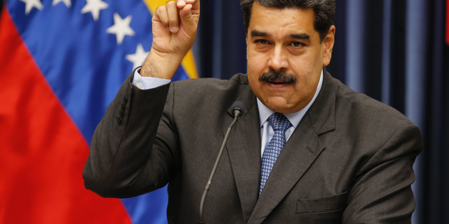 Venezuela's President Nicolas Maduro demonstrates his Salt Bae sprinkling technique during a press conference at the Miraflores Presidential Palace, in Caracas, Venezuela, Tuesday, Sept. 18, 2018. Maduro demonstrated the technique after speaking about the invitation to the famed Nusr-Et steakhouse in Istanbul when he stopped over briefly in Turkey on the way home from a trip to China to raise badly needed investment. Videos of Maduro feasting on a steak is drawing fury from opponents of the embattled socialist leader. (AP Photo/Ariana Cubillos)