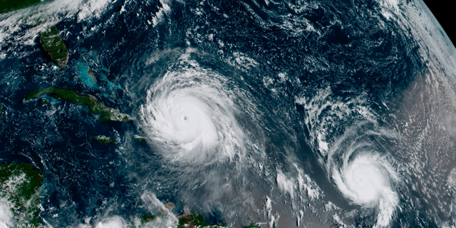 FILE - This Thursday, Sept. 7, 2017 satellite image made available by NOAA shows the eye of Hurricane Irma, left, just north of the island of Hispaniola, with Hurricane Jose, right, in the Atlantic Ocean. Six major hurricanes _ with winds of at least 111 mph (178 kph) _ spun around the Atlantic in 2017, including Harvey, Irma and Maria which hit parts of the United States and the Caribbean. (NOAA via AP)