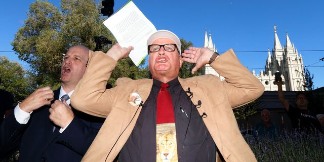 Sam Young reacts after reading a letter detailing his excommunication proceedings from the Mormon Church during a news conference Sunday, Sept. 16, 2018, near Temple Square, in Salt Lake City. Young, a Mormon man who led a campaign criticizing the church's practice of allowing closed-door, one-on-one interviews of youth by lay leaders has been kicked out of the faith. Young, a 65-year-old lifelong Mormon, becomes the third high-profile member of the faith who led protests about church policy to be excommunicated in recent years. (AP Photo/Rick Bowmer)