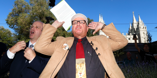 Sam Young reacts after reading a letter detailing his excommunication proceedings from the Mormon Church during a news conference Sunday, Sept. 16, 2018, near Temple Square, in Salt Lake City. Young, a Mormon man who led a campaign criticizing the church's practice of allowing closed-door, one-on-one interviews of youth by lay leaders has been kicked out of the faith. Young, a 65-year-old lifelong Mormon, becomes the third high-profile member of the faith who led protests about church policy to be excommunicated in recent years. (AP Photo/Rick Bowmer)