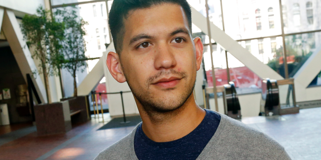 In this Friday, Sept. 7, 2018 photo, Chris Damian poses in Minneapolis. Damian believes having more nuanced conversations about hard topics like sex abuse by priests and allegations of cover-ups by church leaders can bring about change. Damian, 27, has organized a group of Catholic young adults to respond to the church crisis. (AP Photo/Jim Mone)