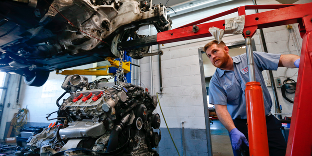 In this April 26, 2018, photo automotive technician Don Dimond prepares to separate an engine and transmission assembly at a repair shop in Harmony, Pa. On Thursday, Sept. 6, the Institute for Supply Management, a trade group of purchasing managers, issues its index of non-manufacturing activity for August. (AP Photo/Keith Srakocic)