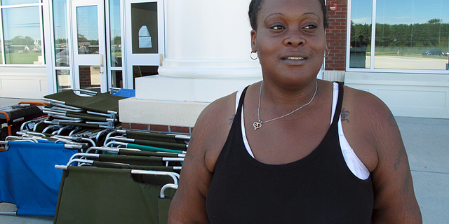 In this Tuesday, Sept. 18, 2018, photo, Lutrice Garcia stands outside a Red Cross shelter where she's staying, at a school in Bennettsville, S.C. Garcia said her nearby home was damaged by flooding caused by Hurricane Florence, and she doesn't know if she'll be able to return there to live once the water recedes. (AP Photo/Russ Bynum)