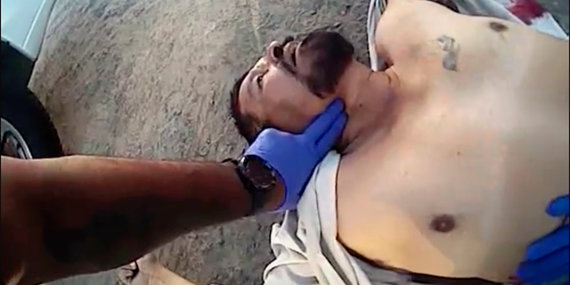 EDITORS NOTE CONTENTS - This photo from video from a deputy's body camera, provided by the Kern County, Calif., Sheriff's Office, shows officers and others treating Javier Casarez, 54, moments after he fatally shot himself, during a confrontation in Bakersfield, Calif., Wednesday, Sept. 12, 2018. Kern County Sheriff Donny Youngblood Thursday identified Cazarez as the gunman who fatally shot his ex-wife and a man at a trucking company before chasing after another man, killing him, and then driving to a home where he shot dead a father and daughter in a nearly 40-minute rampage Wednesday. (Kern County Sheriff's Office via AP)