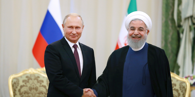 Iran's President Hassan Rouhani, right, shakes hands with Russia's President Vladimir Putin, in Tehran, Iran, Friday, after their talks, part of Russia-Iran-Turkey summit to discuss Syria, Friday Sept. 7, 2018. Putin, Erdogan and Iran's President Hassan Rouhani began a meeting Friday in Tehran to discuss the war in Syria, with all eyes on a possible military offensive to retake the last rebel-held bastion of Idlib. (AP Photo/Ebrahim Noroozi)