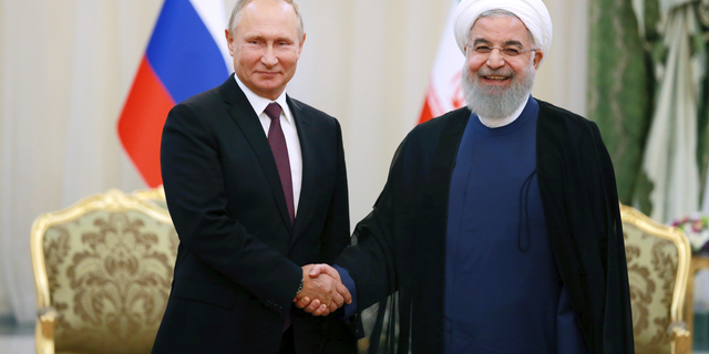 Iran's President Hassan Rouhani, right, shakes hands with Russia's President Vladimir Putin, in Tehran, Iran, Friday, after their talks, part of Russia-Iran-Turkey summit to discuss Syria, Friday Sept. 7, 2018. Putin, Erdogan and Iran's President Hassan Rouhani began a meeting Friday in Tehran to discuss the war in Syria, with all eyes on a possible military offensive to retake the last rebel-held bastion of Idlib. (AP Photo/Ebrahim Noroozi)