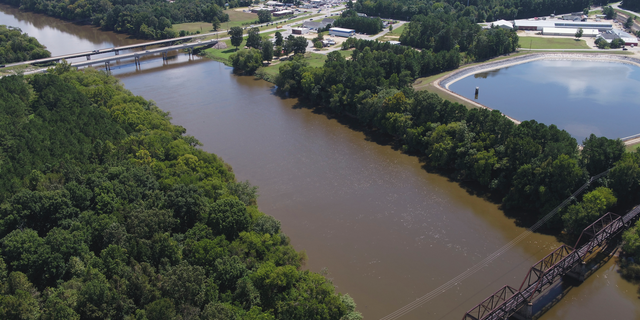 FILE - In this Tuesday afternoon, Sept. 12, 2018 file photo provided by DroneBase, an aerial view of the Cape Fear River, N.C., in Buckhorn, N.C. is shown ahead of Hurricane Florence. Record flooding is expected on North Carolina's Cape Fear River in the coming week, and signs of the coming flood are already apparent. The Cape Fear River is predicted to crest at 62 feet (nearly 19 meters) in Fayetteville on Tuesday, Sept. 18. (DroneBase via AP, File)
