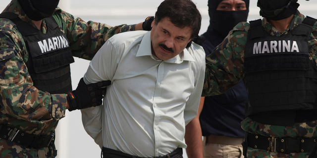 FILE - In this Feb. 22, 2014, file photo, Joaquin "El Chapo" Guzman is escorted to a helicopter in handcuffs by Mexican Navy marines in Mexico City, Mexico. A . (AP Photo/Eduardo Verdugo, File)