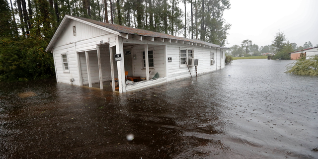 A home is seen in floodwaters from Hurricane Florence in Marion, S.C., Sunday, Sept. 16, 2018. (AP Photo/Gerald Herbert)