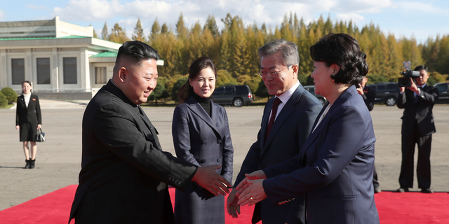 North Korean leader Kim Jong Un, left, flanked by his wife Ri Sol Ju, second from left, bids farewell to South Korean President Moon Jae-in, second from right, and his wife Kim Jung-sook, at Samjiyon airport, in North Korea, Thursday, Sept. 20, 2018. A beaming South Korean President Moon, freshly returned home Thursday from a whirlwind three-day summit with Kim Jong Un, said the North Korean leader wants the U.S. secretary of state to visit Pyongyang soon for nuclear talks, and also hopes for a quick follow-up to his June summit with President Donald Trump. (Pyongyang Press Corps Pool via AP)