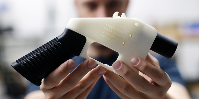 FILE - In this Aug. 1, 2018, file photo, Cody Wilson, with Defense Distributed, holds a 3D-printed gun called the Liberator at his shop in Austin, Texas. Police allege in an affidavit filed Wednesday, Sept. 19, that Wilson had sex with an underage girl and paid her $500 afterward. Austin police Detective Shaun Donovan wrote in a request for a warrant to arrest Wilson on a sexual assault charge. The court filing doesn't say how old the girl is, but Texas' age of consent is 17. (AP Photo/Eric Gay, File)