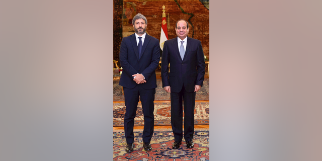 In this photo released by the Egyptian Presidency, Egyptian President Abdel-Fattah el-Sissi, right, poses for a photo with Roberto Fico, president of Italy's Chamber of Deputies, at the presidential palace in Cairo, Egypt, Monday, Sept. 17, 2018. Fico said a final resolution of the 2016 killing of a graduate student in Egypt will help boost relations between the two nations. A presidential statement said el-Sissi assured Fico of his nation's commitment to "full transparency" in its cooperation with Italy on the case. (Egyptian Presidency via AP)
