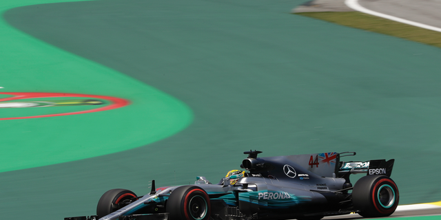 Mercedes Formula One racer Lewis Hamilton says members of his team were robbed at gun point in Brazil.