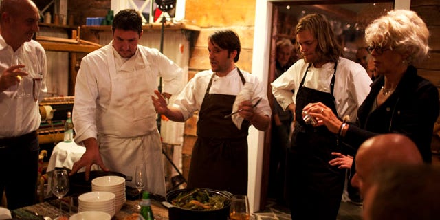 In this September 2010 photo released by Cook It Raw shows Rene Redzepi, and his team presenting the final dish on the last evening during "Cook It Raw" in Lapland, Finland. The event marked the third time in just over a year that this international group of chefs have hunted, fished and foraged together in a particular location, then prepared a meal while leaving the smallest possible footprint on the environment. (AP)