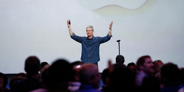 Apple CEO Tim Cook greets the audience during an Apple event announcing the iPhone 6 and the Apple Watch.