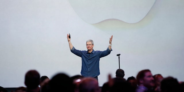 Apple CEO Tim Cook greets the audience during an Apple event announcing the iPhone 6 and the Apple Watch.