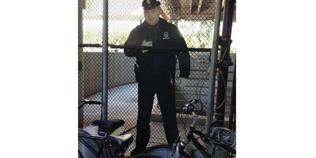 As part of an effort to cut crime, transit police placed a cardboard cutout of a police officer in the bicycle cage.