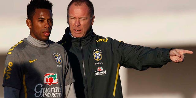 Brazil's soccer coach Mano Menezes, right, talks to player Robinho during a training session ahead of the upcoming 2011 Copa America in Campana, Argentina, Monday, June 27, 2011. Argentina will host the Copa America soccer tournament from July 1 to July 24. (AP Photo/Natacha Pisarenko)