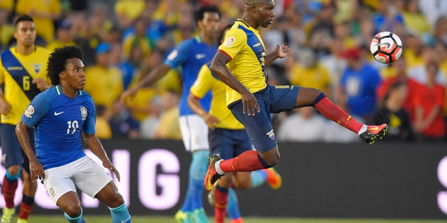 Ecuador midfielder Walter Ayovi, right, kicks the ball as Brazil midfielder Willian, left, watches during a Copa America group B soccer match at the Rose Bowl, Saturday, June 4, 2016, in Pasadena, Calif. (AP Photo/Mark J. Terrill)