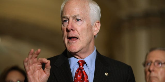 WASHINGTON, DC - OCTOBER 06: Senate Majority Whip John Cornyn (R-TX) (L) talks to reporters after the weekly Republican policy luncheon at the U.S. Capitol October 6, 2015 in Washington, DC. Senate Republicans and Democrats are engaged in budget negotiations in an attempt to avert a possible federal government shutdown on December 11. (Photo by Chip Somodevilla/Getty Images)