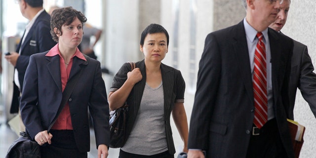 Aug. 29, 2012: Hanjuan Jin, center, leaves a federal courthouse in Chicago after being sentenced to four years in prison for stealing trade secrets from Motorola.