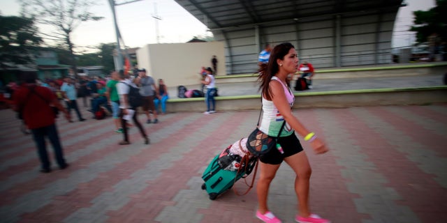 A Cuban migrant walks to the airport in La Cruz, Costa Rica, Tuesday, Jan. 12, 2016.