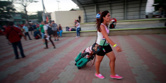 A Cuban migrant walks to the airport in La Cruz, Costa Rica, Tuesday, Jan. 12, 2016.