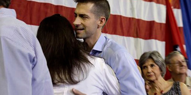 FILE: Aug. 6, 2013: Rep. Tom Cotton, R-Ark., center, greets a supporter after announcing his candidacy for Senate, in Dardanelle, Ark.