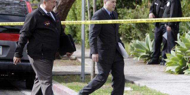 April 11: LAPD investigators work at the scene of a shooting of two USC students in Los Angeles. Police said a gunman opened fire on a BMW near the University of Southern California campus, killing two international students from China in what may have been a bungled carjacking attempt.