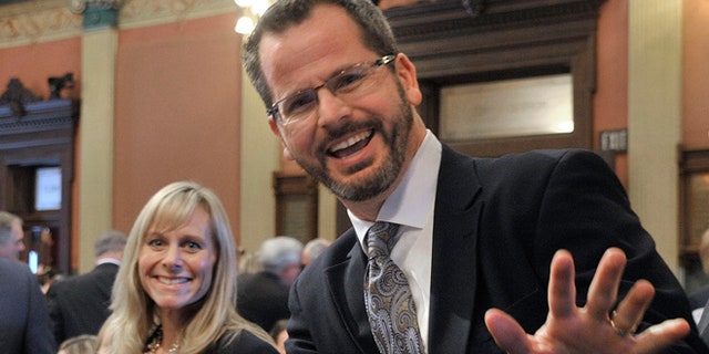 In this Jan. 14, 2015 photo, Michigan state Rep. Cindy Gamrat and state Rep. Todd Courser wave to reporters in the House of Representatives in Lansing.