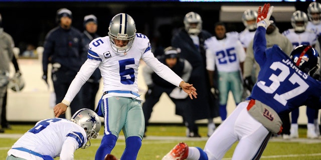 Dallas Cowboys kicker Dan Bailey (5), with Chris Jones holding, kicks a game-winning field goal against the New York Giants during the second half of an NFL football game, Sunday, Nov. 24, 2013, in East Rutherford, N.J.