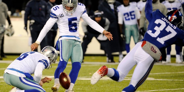 Dallas Cowboys kicker Dan Bailey (5), with Chris Jones holding, kicks a game-winning field goal against the New York Giants during the second half of an NFL football game, Sunday, Nov. 24, 2013, in East Rutherford, N.J.